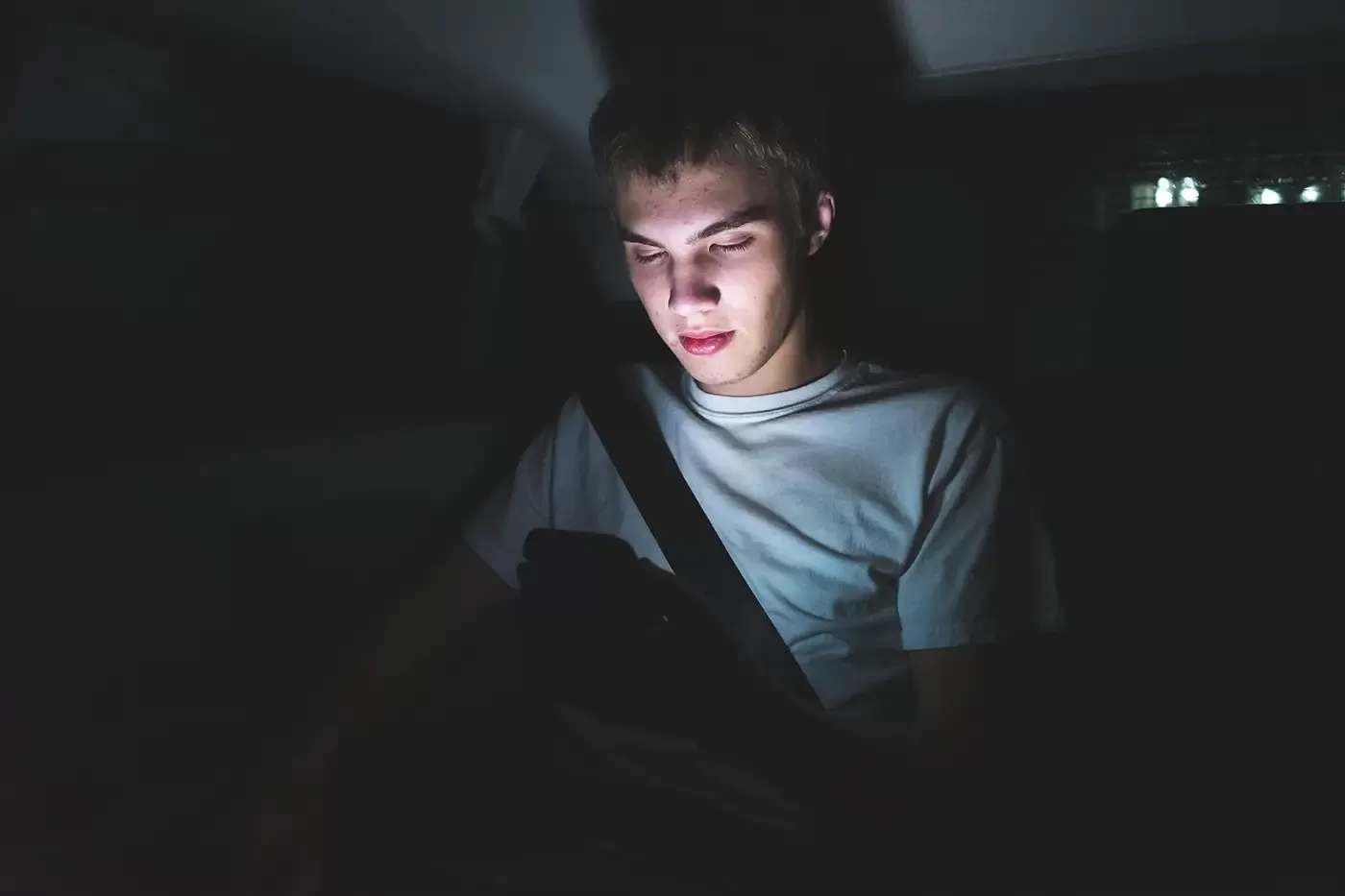 Photo of a teen male in the bnack of an SUV