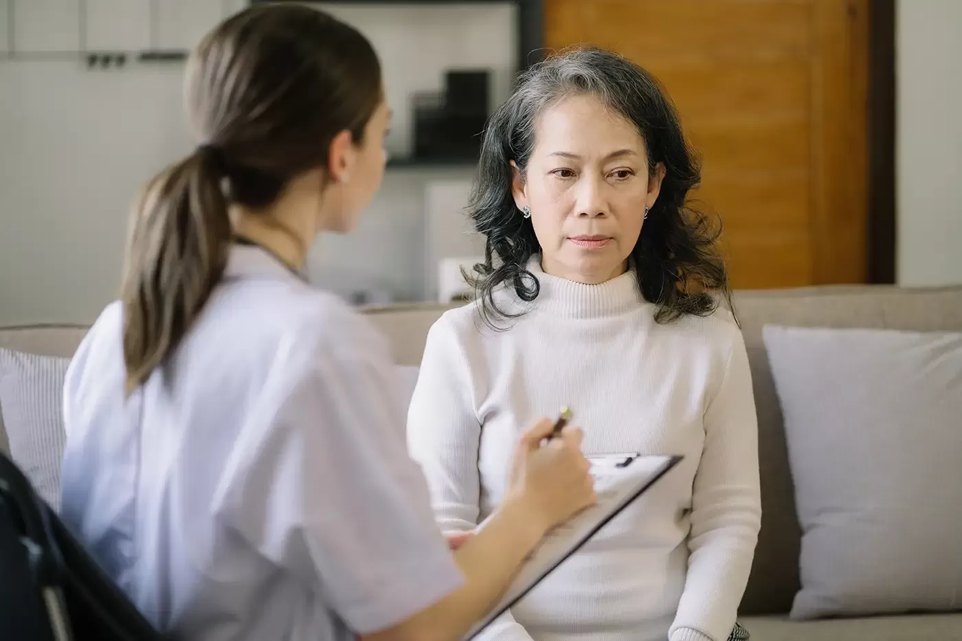 Photo of  a senior patient treated by a psychiatrist in a clinic. 