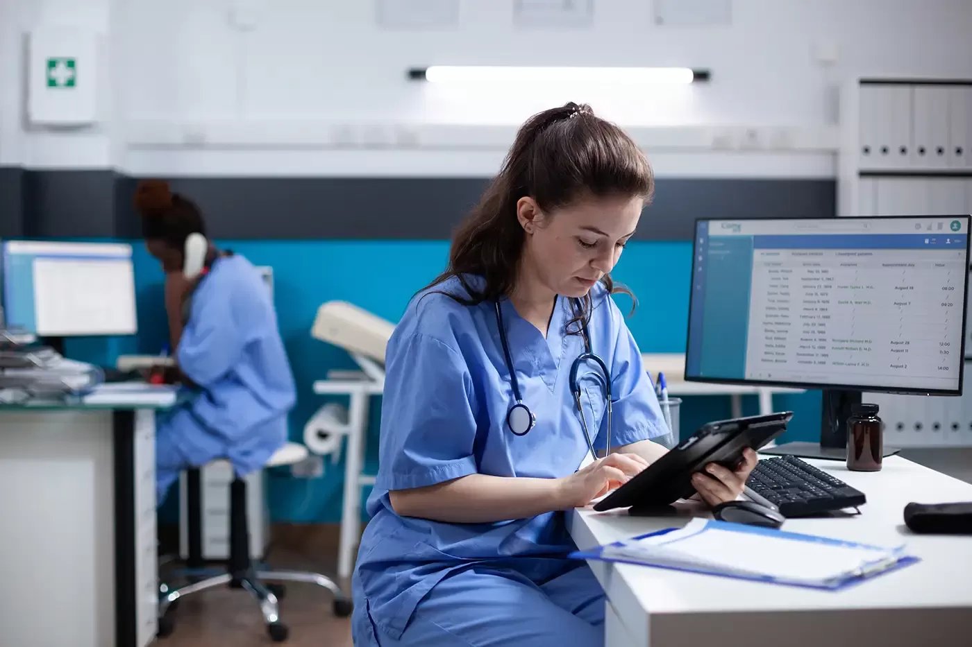 Photo of a nurse completing a webform on a tablet