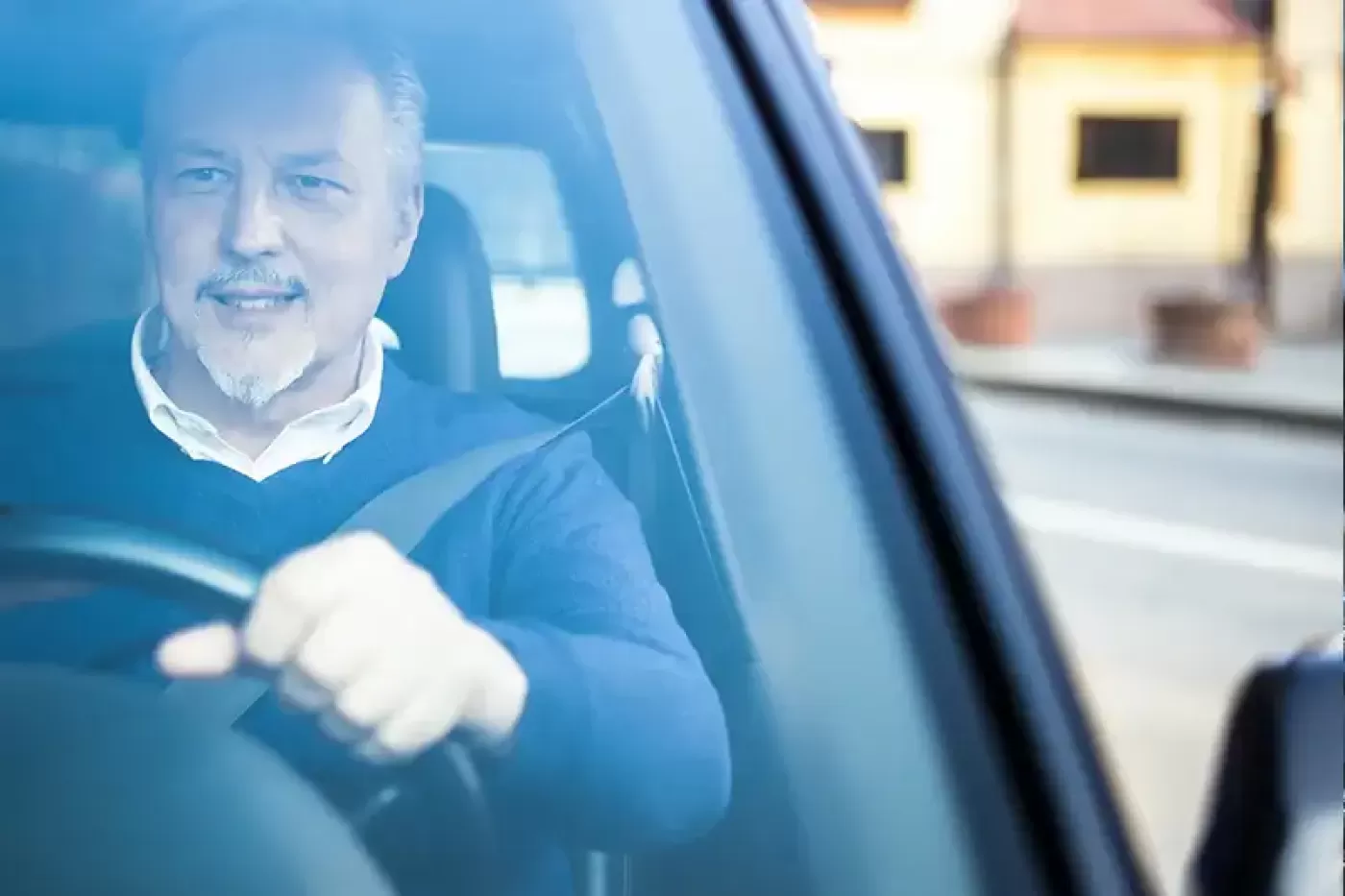 Photo of a driver behind a wheel of a vehicle